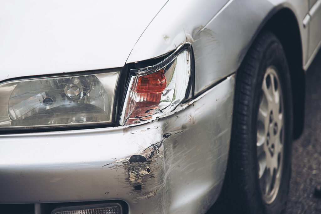 Car damage on road accident - car insurance concept